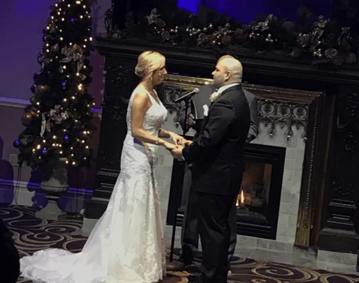 A couple exchanging vows at an outdoor ceremony