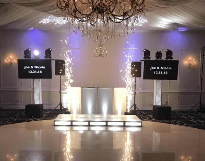 Cold spark fountains framing a DJ setup