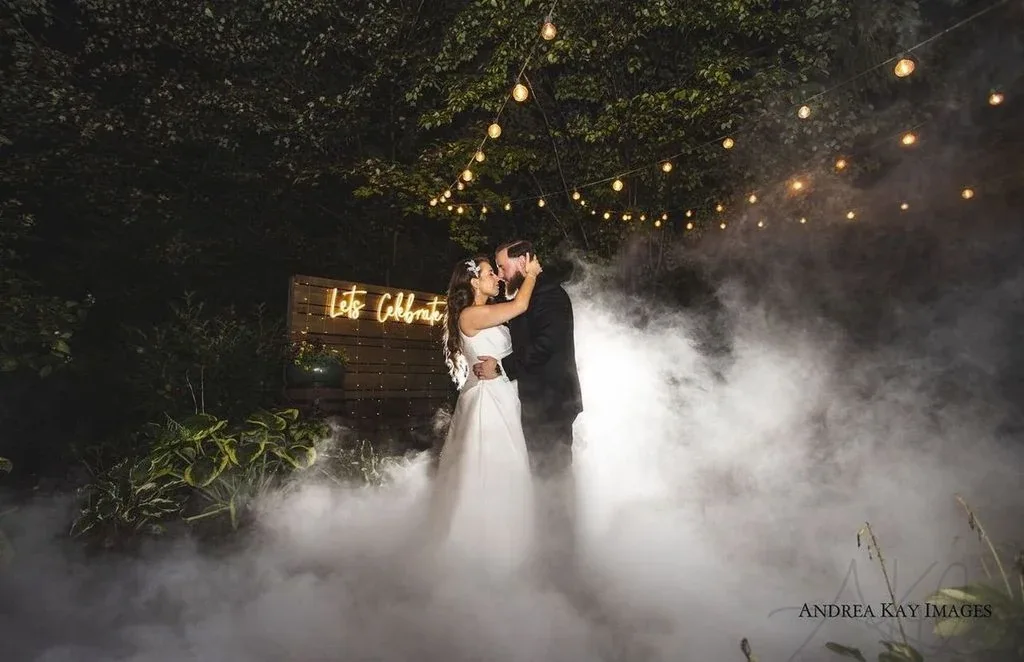 A couple dancing outdoors in a cloud of low-lying fog