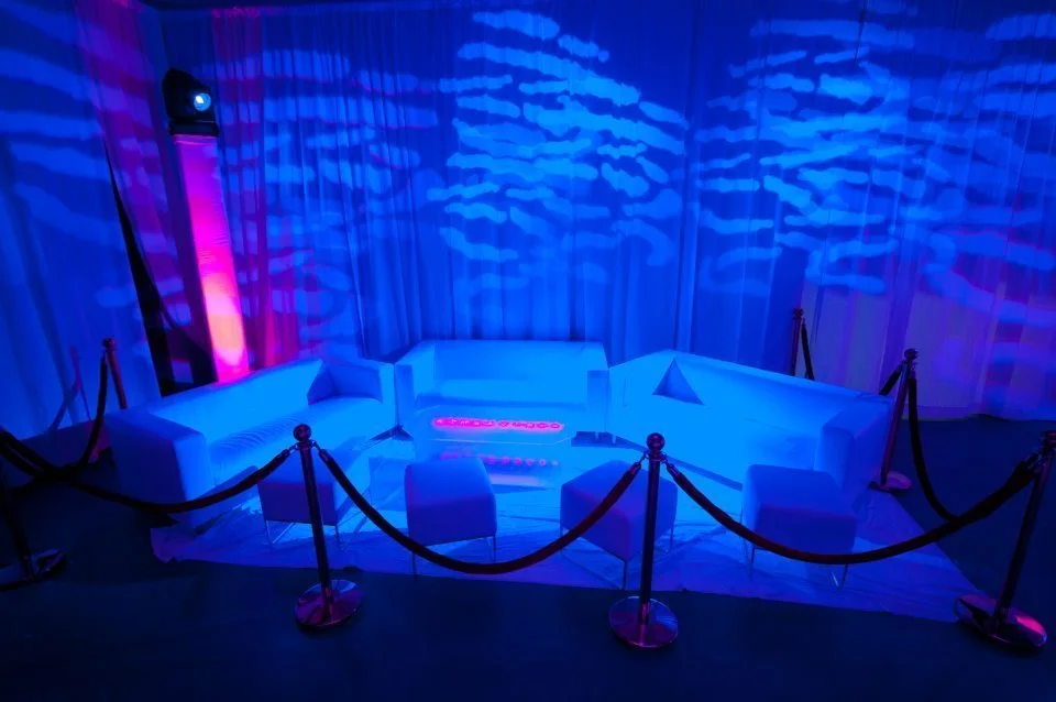 Decorative patterns projected across a blue-lit ballroom