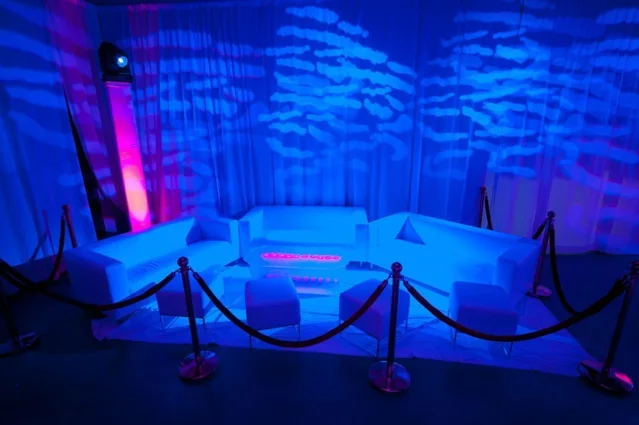 Decorative patterns projected across a blue-lit ballroom