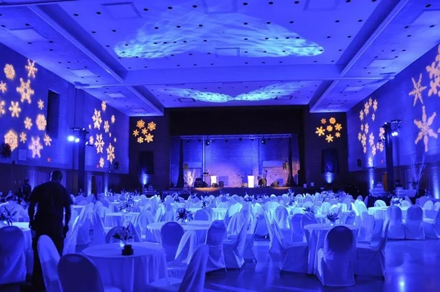 Truss-mounted lighting beside an illuminated DJ booth